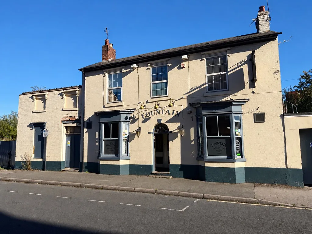 The Fountain Inn in Walsall, a cream-painted pub with bay windows on a quiet road